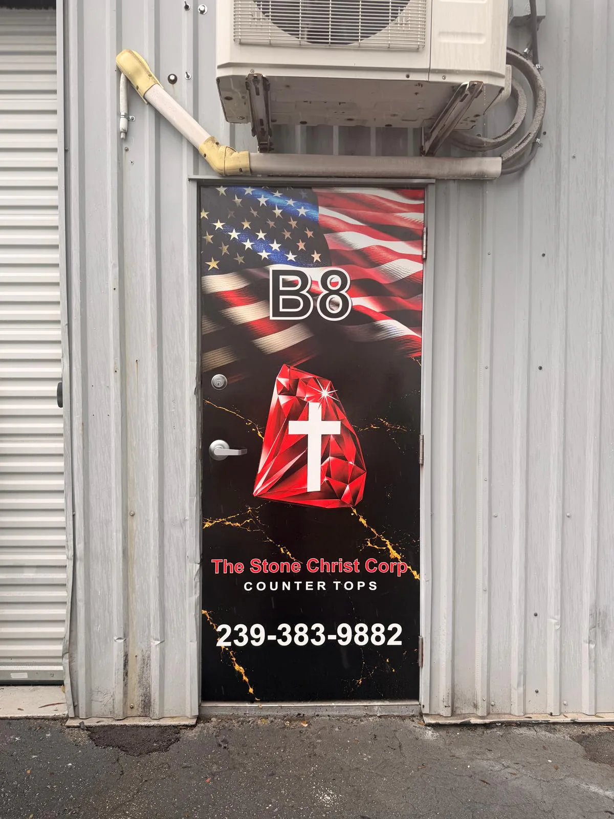 Commercial door covered with black and red business graphics.