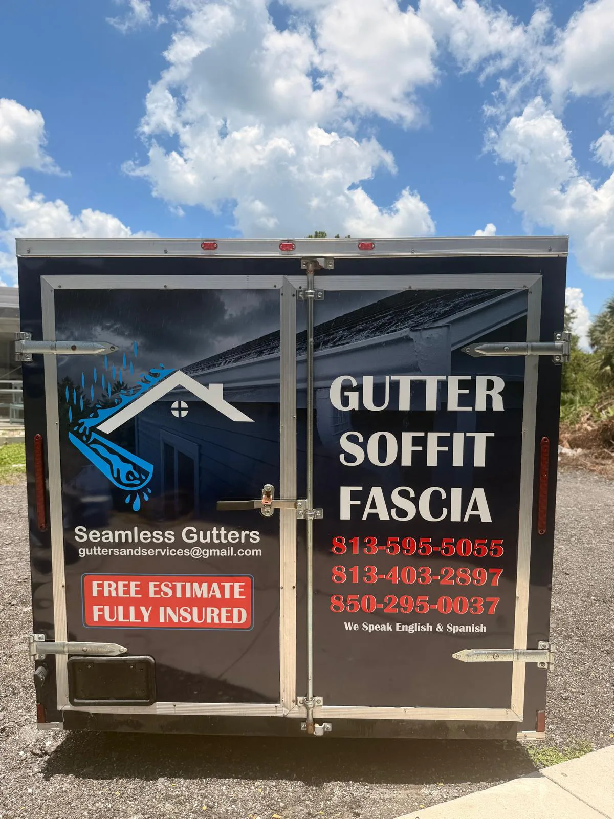 Rear trailer doors covered with contractor branding for gutter and soffit services.