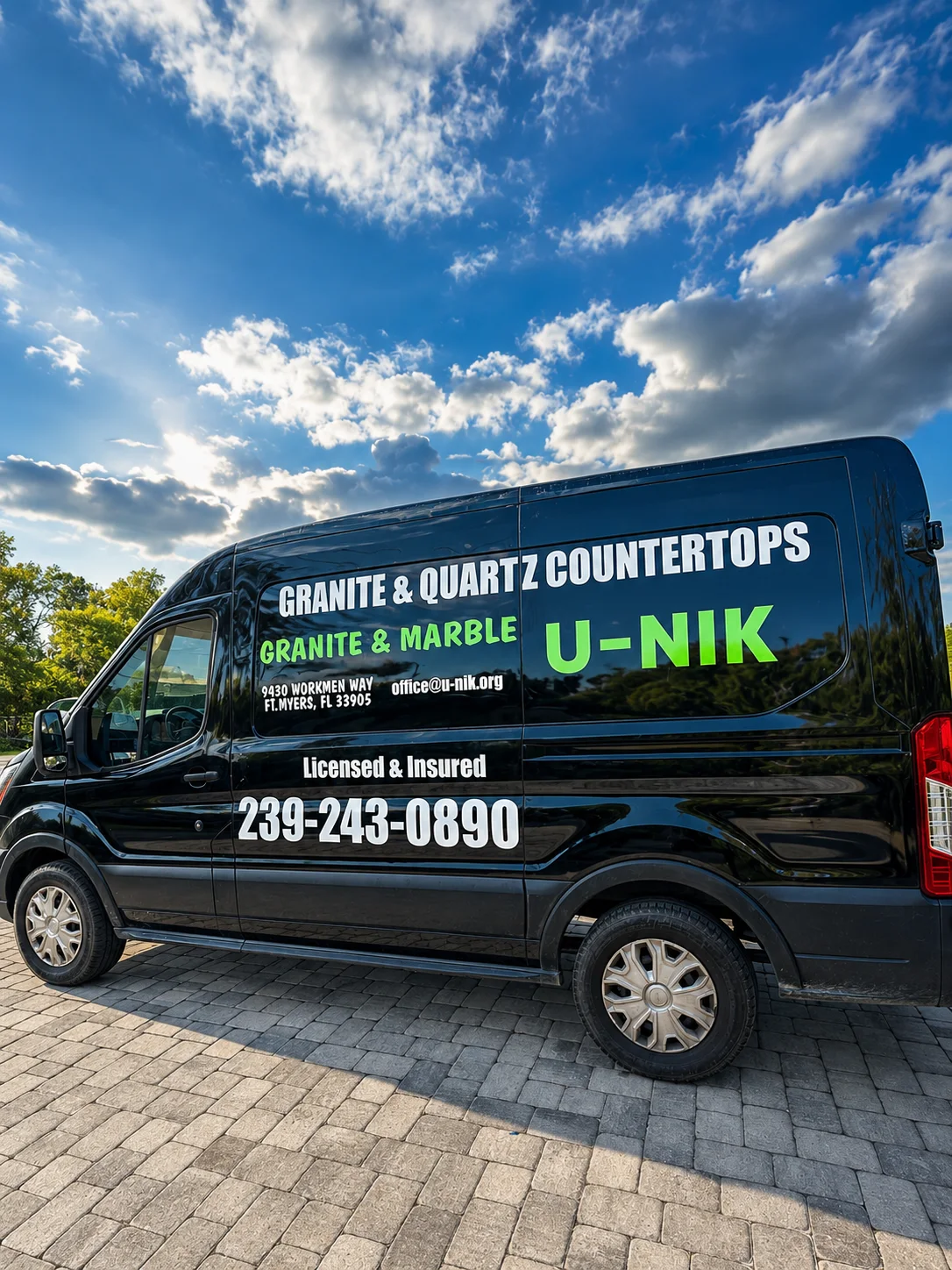 Black commercial van with white and green countertop-business lettering.