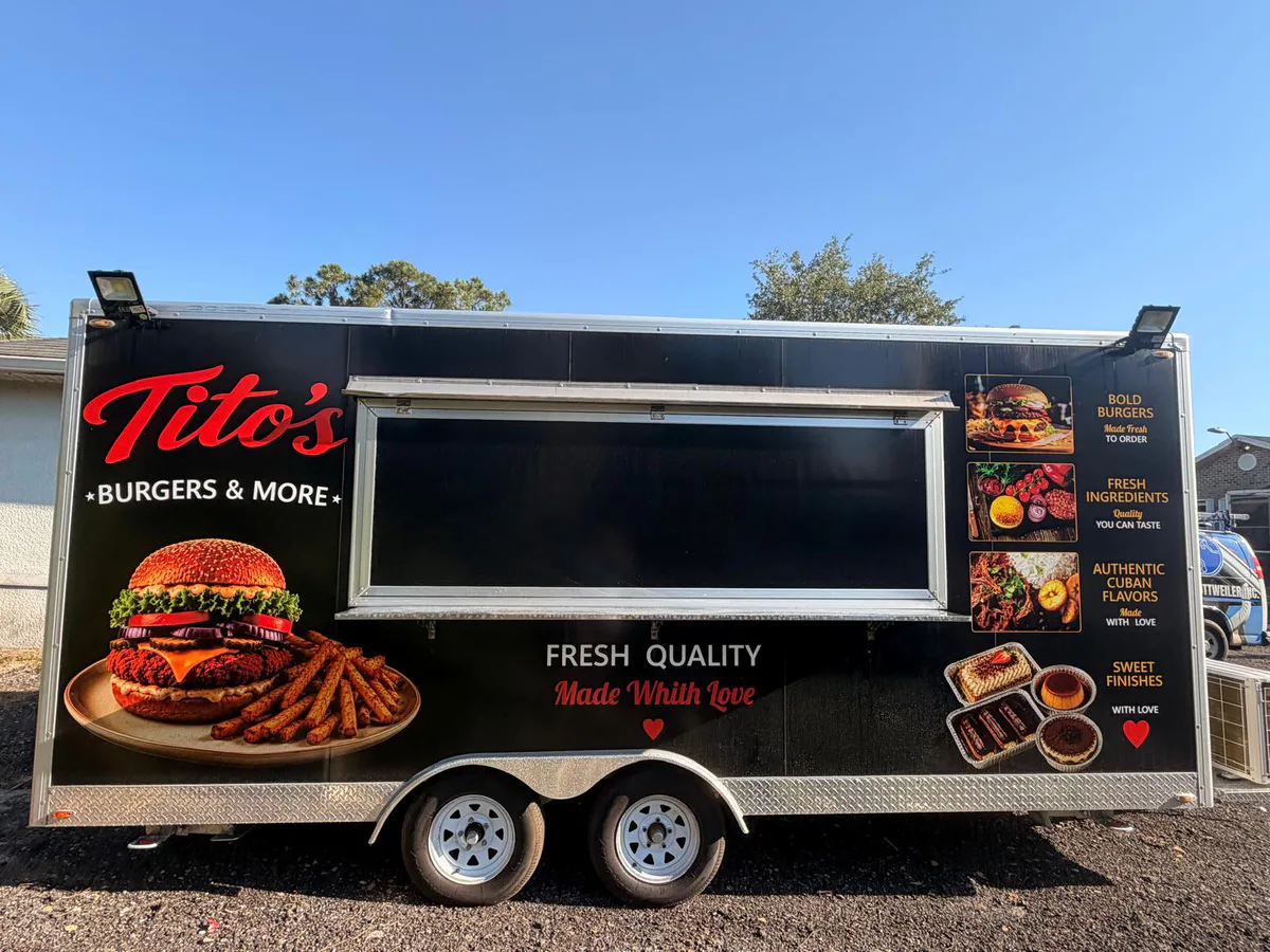 After: black food trailer completed with restaurant branding and food photography.