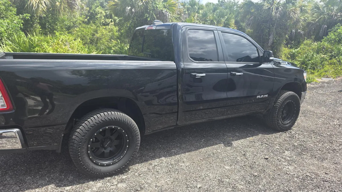 Before: plain black pickup truck without completed commercial graphics.