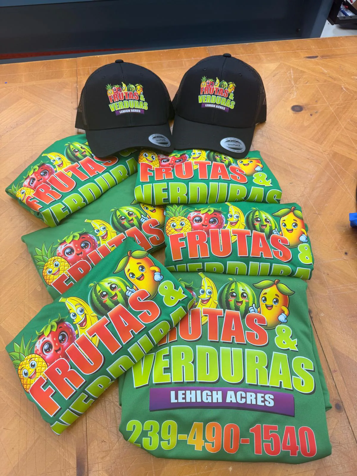 Bright green branded shirts and black caps for a produce business.