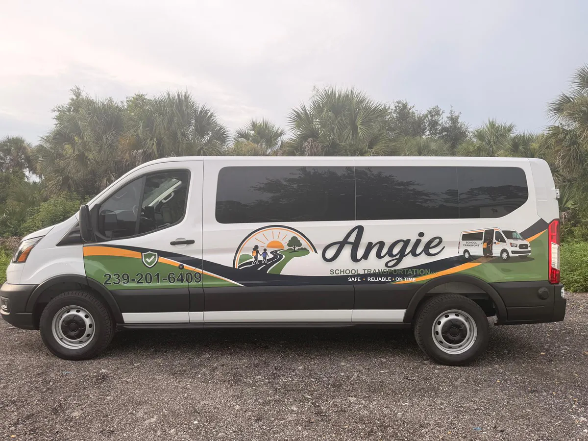 White school transportation van with green and orange partial graphics.